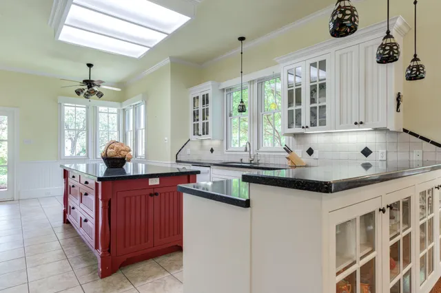 a kitchen with granite countertop a sink and a window