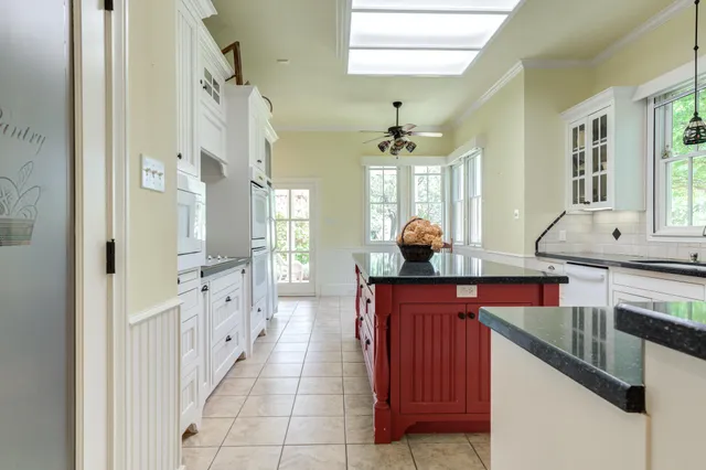 a kitchen with stainless steel appliances white cabinets and a sink