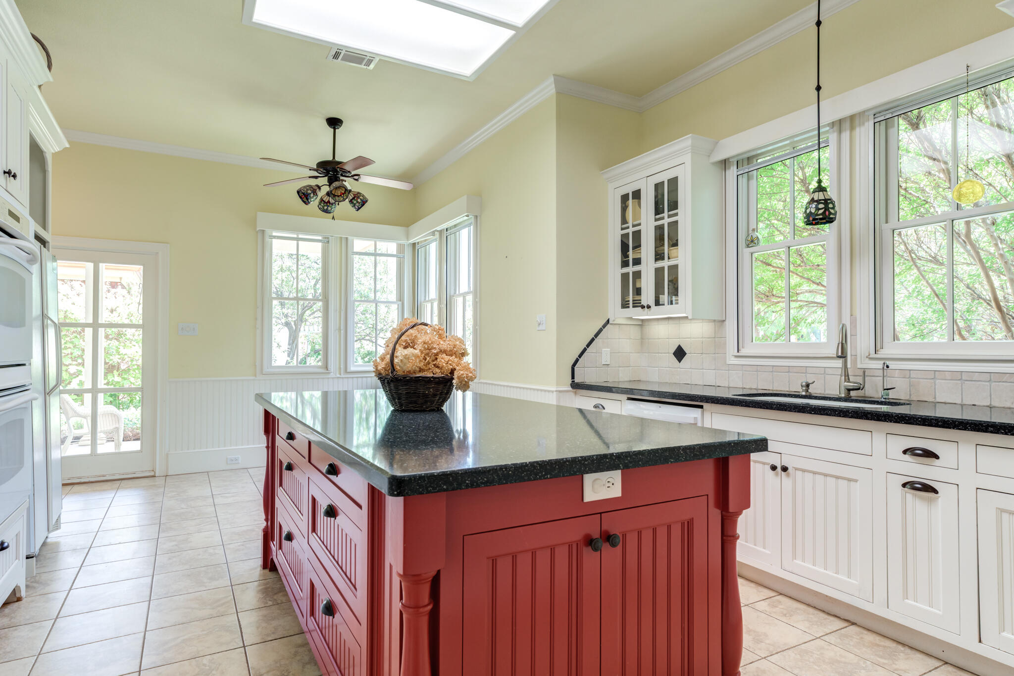 4709 116th Street Lubbock, TX 79424 - Photo 26 of 58 a kitchen with stainless steel appliances granite countertop a sink a stove and a wooden floors
