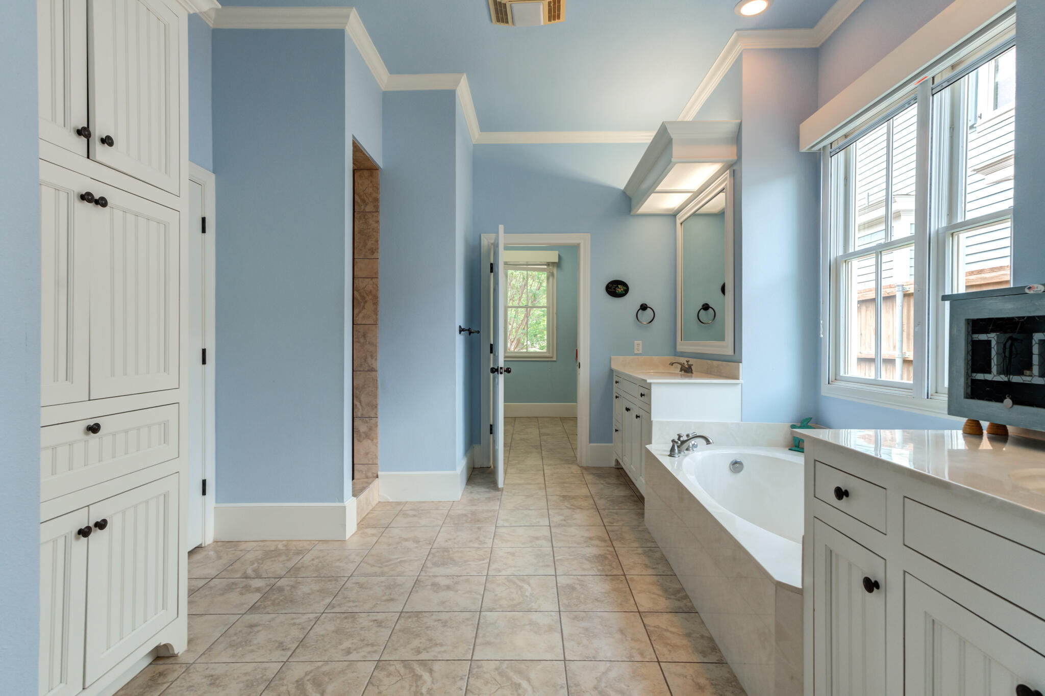 4709 116th Street Lubbock, TX 79424 - Photo 35 of 58 a large en suite bathroom with a tub sink and mirror