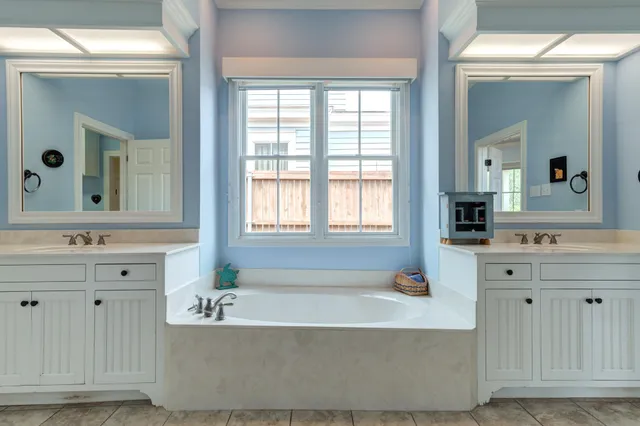 a view of an empty room with furniture and a book shelf