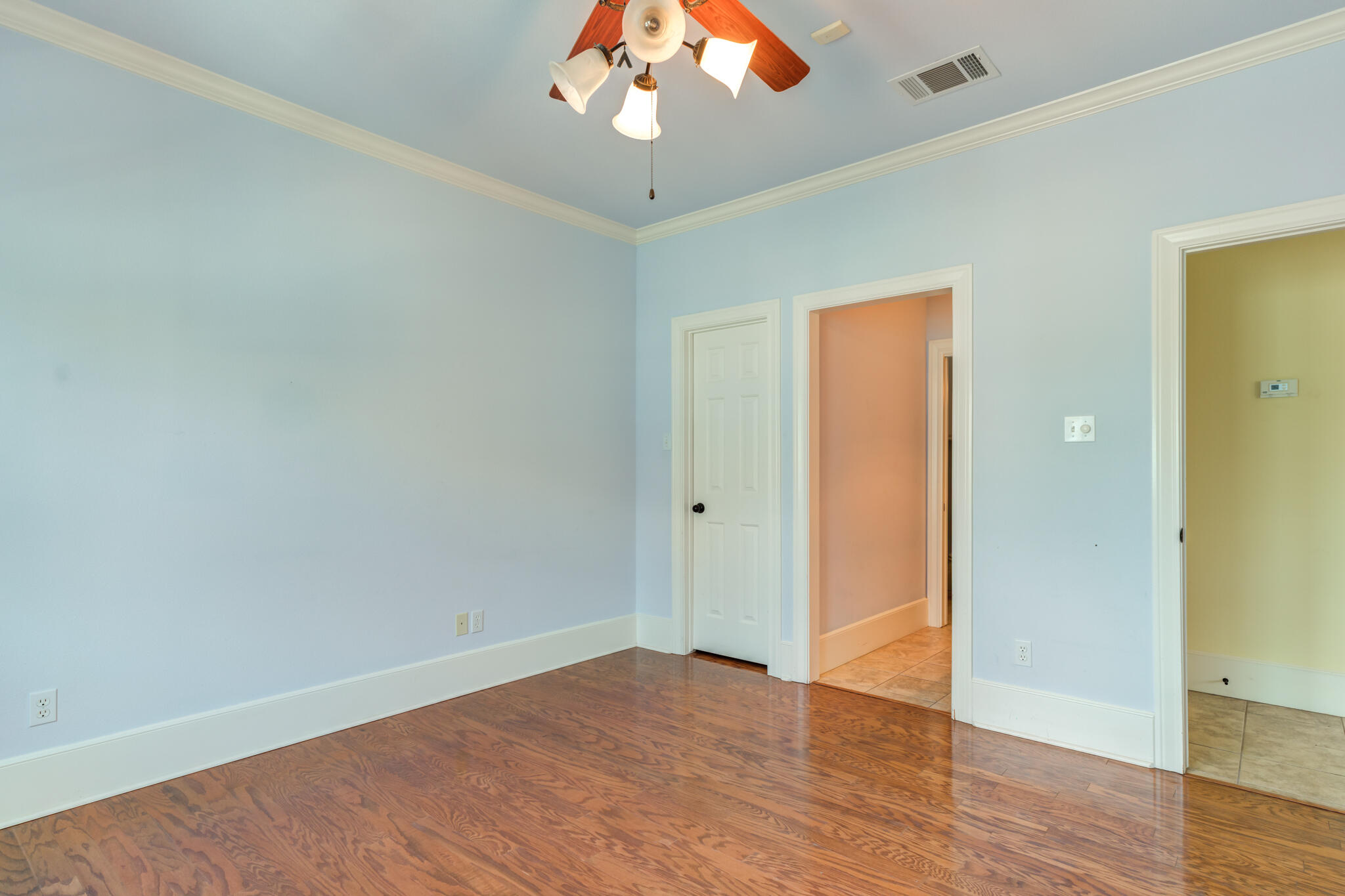 4709 116th Street Lubbock, TX 79424 - Photo 47 of 58 an empty room with wooden floor and a ceiling fan
