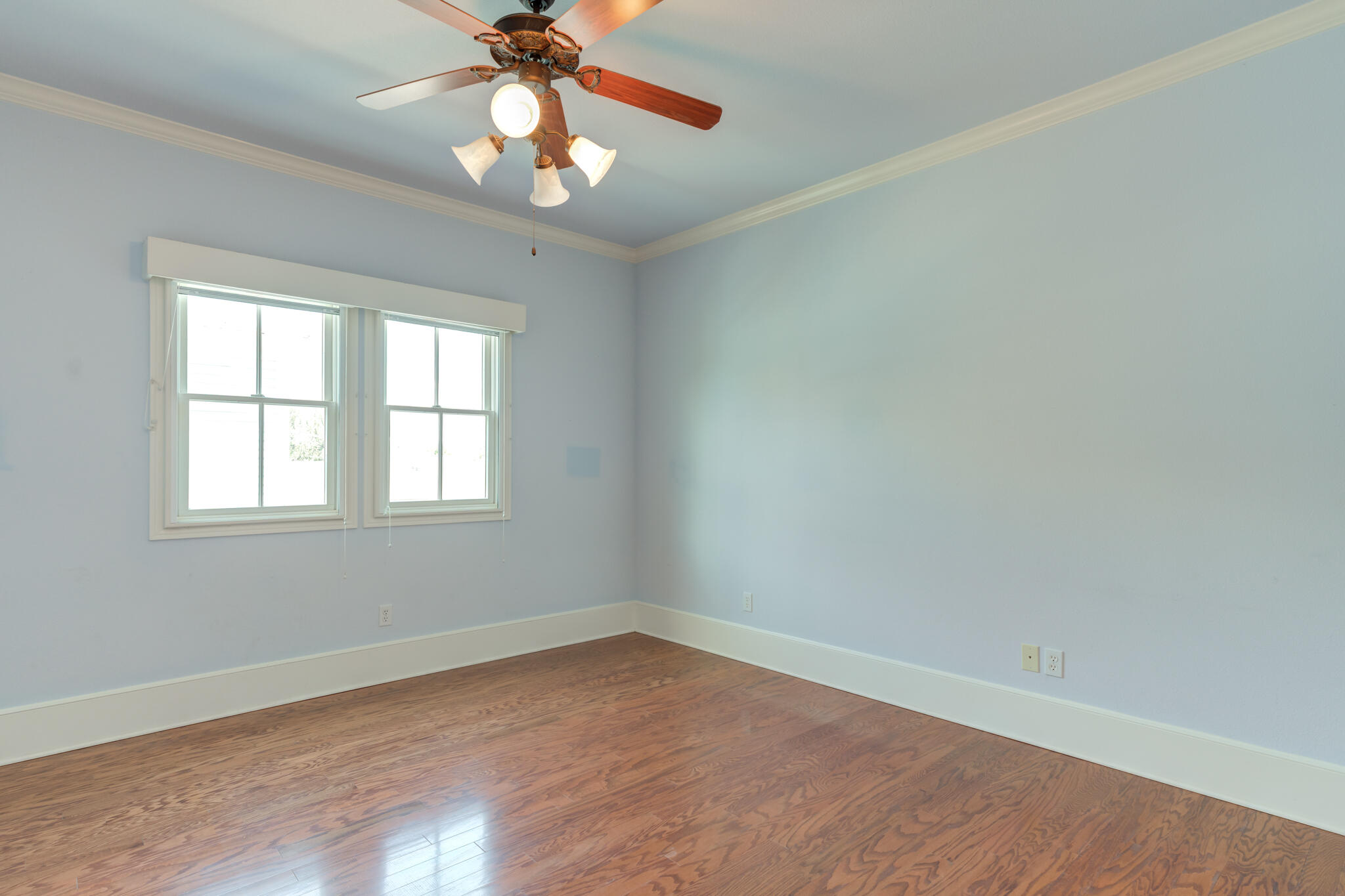 4709 116th Street Lubbock, TX 79424 - Photo 48 of 58 an empty room with wooden floor chandelier fan and windows