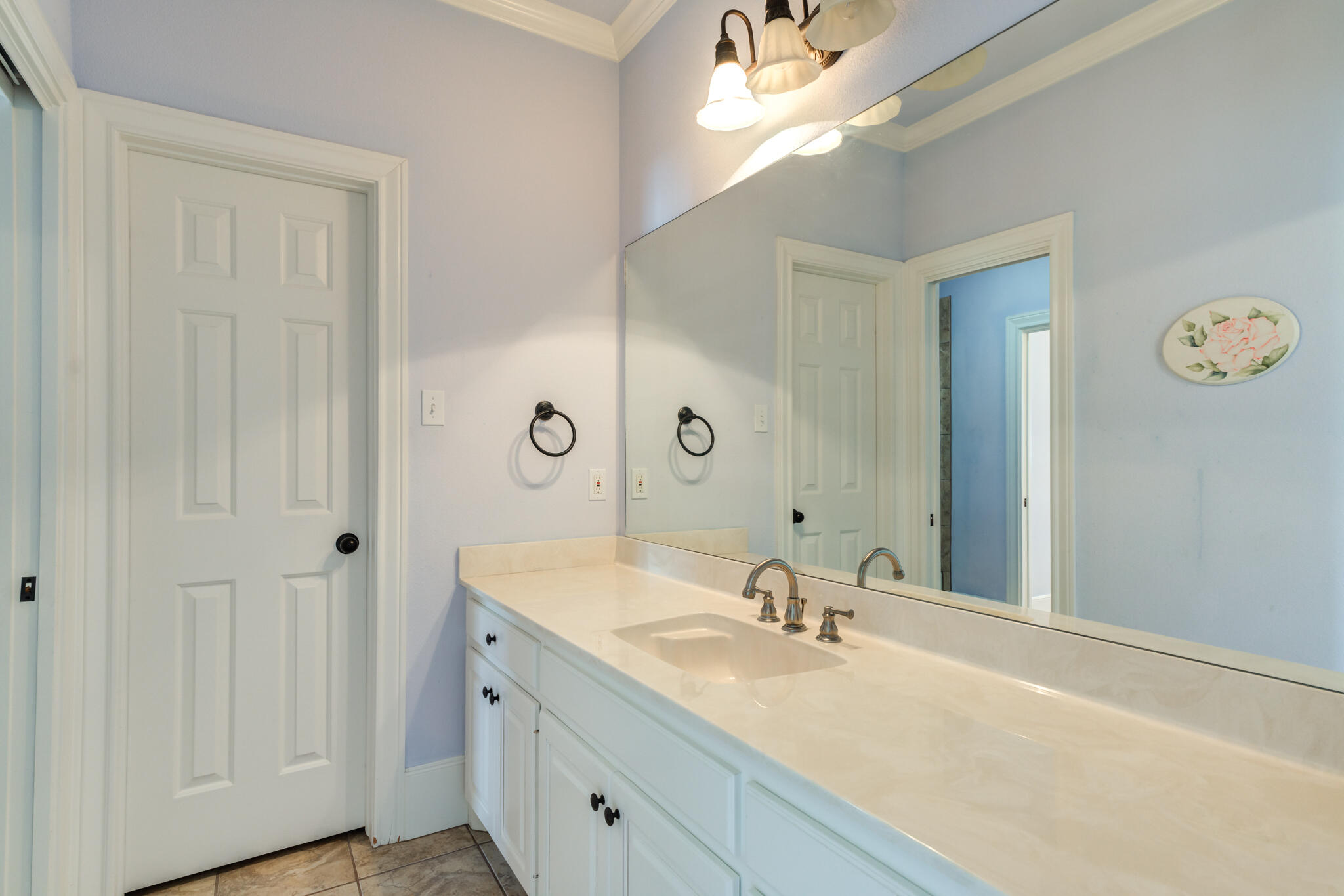 4709 116th Street Lubbock, TX 79424 - Photo 49 of 58 a bathroom with a sink vanity and a mirror