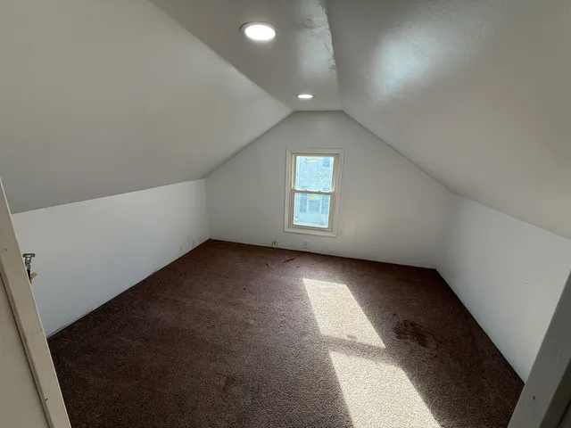 an empty room with a empty space and windows