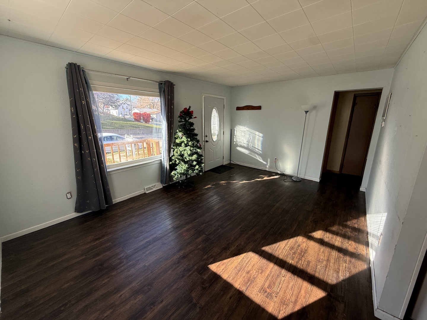 1104 Hemlock Avenue Dixon, IL 61021 - Photo 9 of 19 a view of an empty room with wooden floor and a window