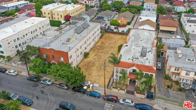 an aerial view of multiple houses with yard
