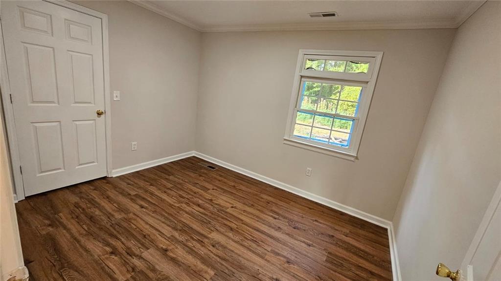 471 Perkins Circle Canton, GA 30115 - Photo 20 of 20 a view of an empty room with wooden floor and a window