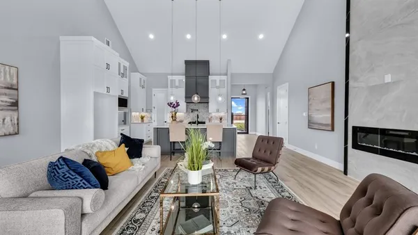 a living room with furniture fireplace and kitchen view