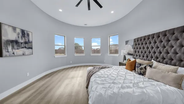 a bedroom with a bed and a lamp