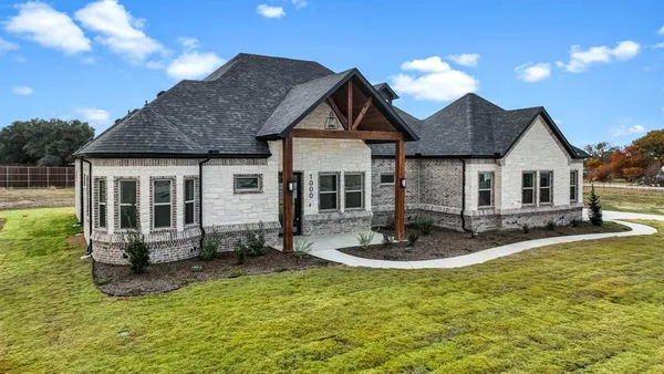 a front view of house with yard outdoor seating and barbeque oven
