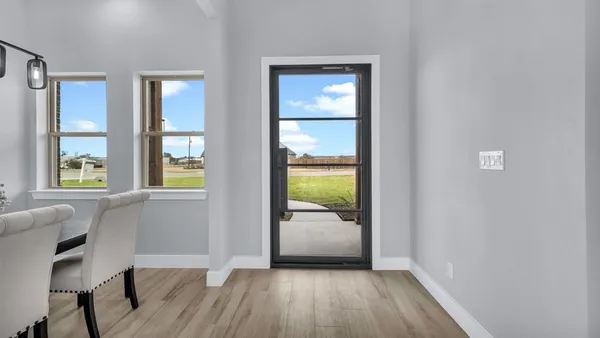 a view of a hallway and a livingroom with furniture