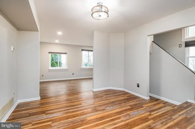 a view of a livingroom with wooden floor and window