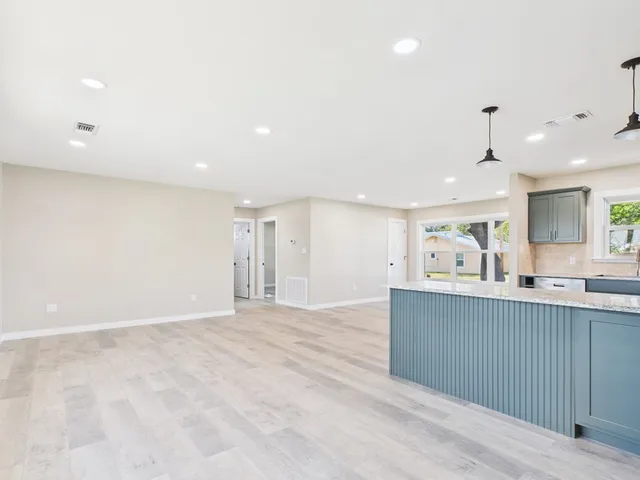 a view of kitchen with sink and window