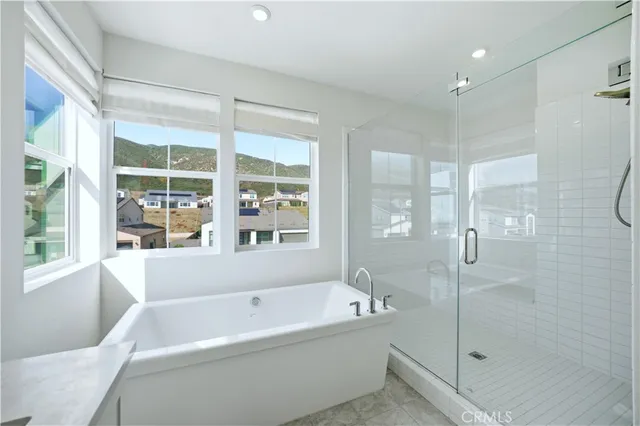 a bedroom with a bed chair and a window