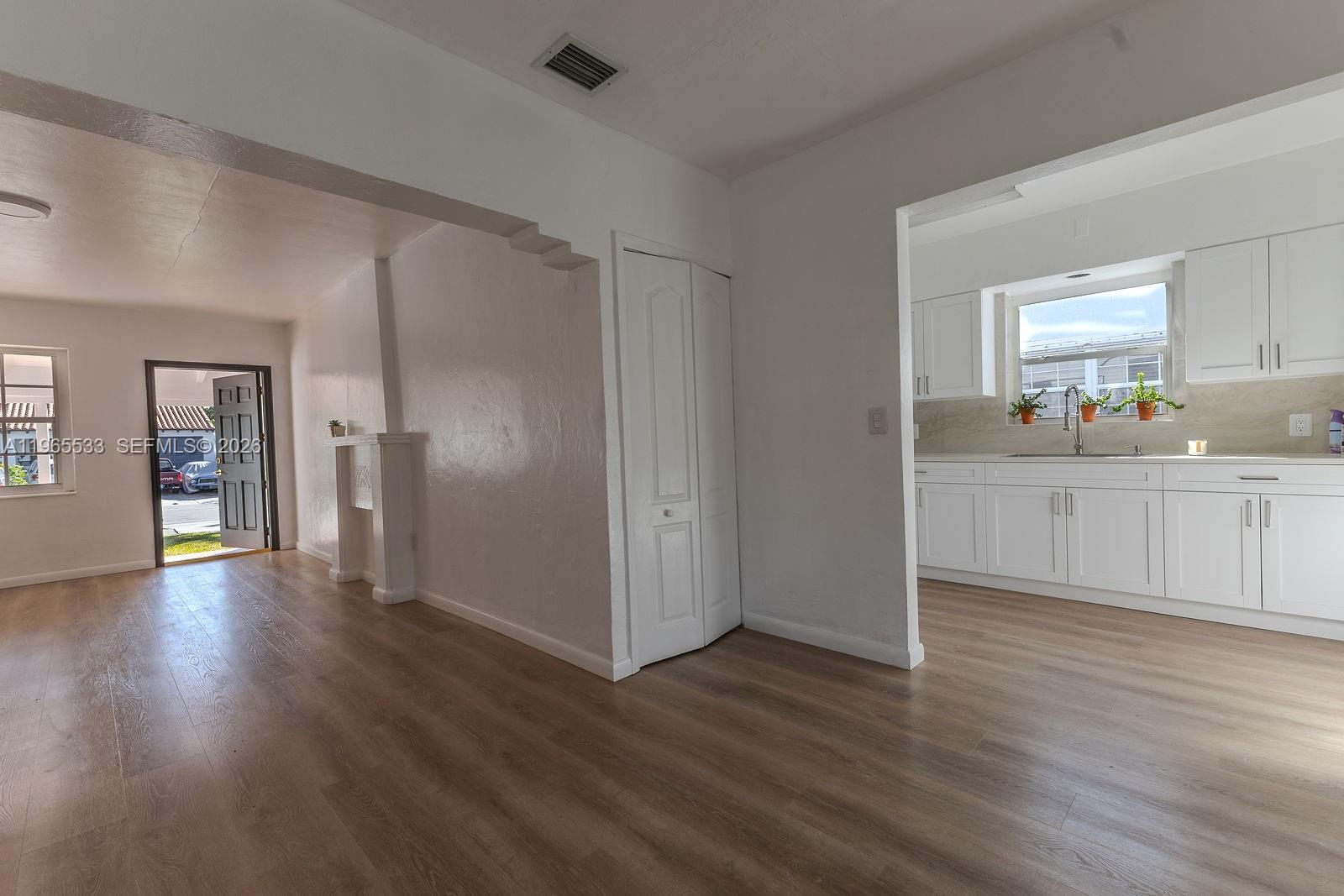 1441 Southwest 17th Street Miami, FL 33145 - Photo 11 of 26 a view of a kitchen with wooden floor and windows