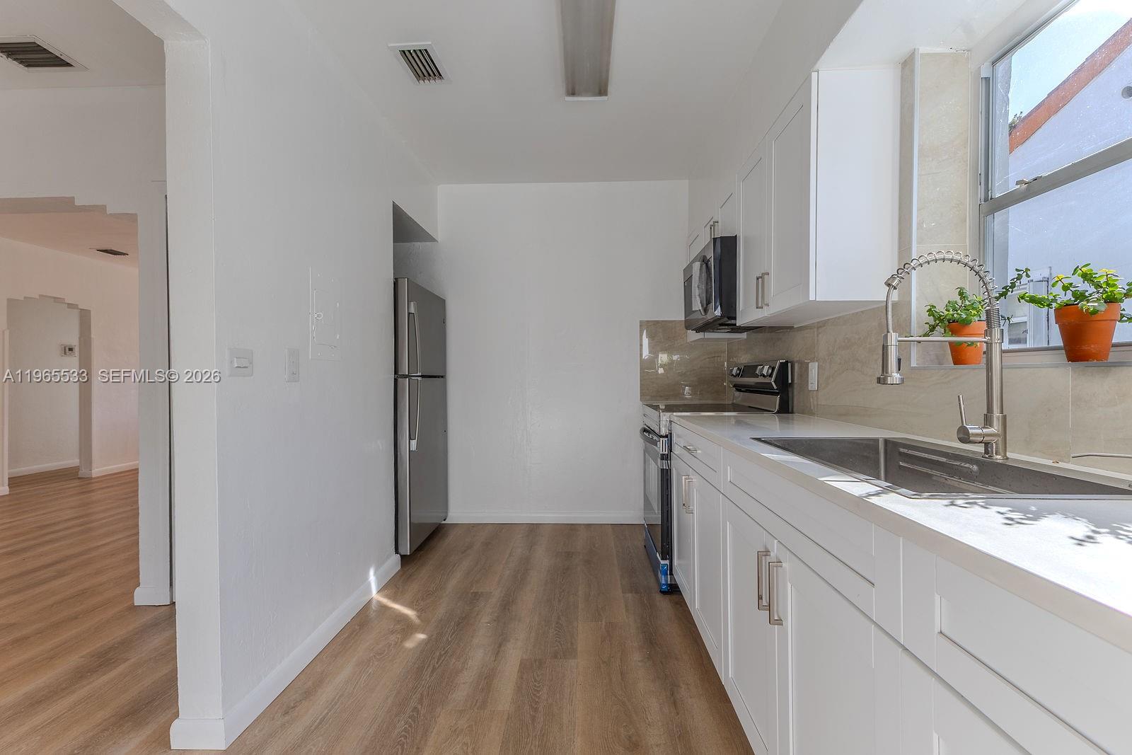 1441 Southwest 17th Street Miami, FL 33145 - Photo 13 of 26 a kitchen with a sink and refrigerator