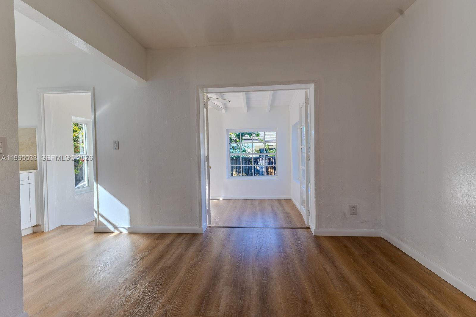1441 Southwest 17th Street Miami, FL 33145 - Photo 16 of 26 an empty room with wooden floor and windows