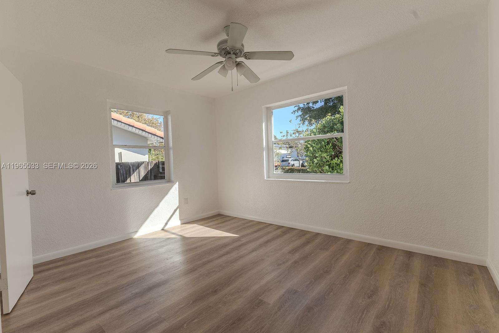 1441 Southwest 17th Street Miami, FL 33145 - Photo 17 of 26 wooden floor in an empty room with a window