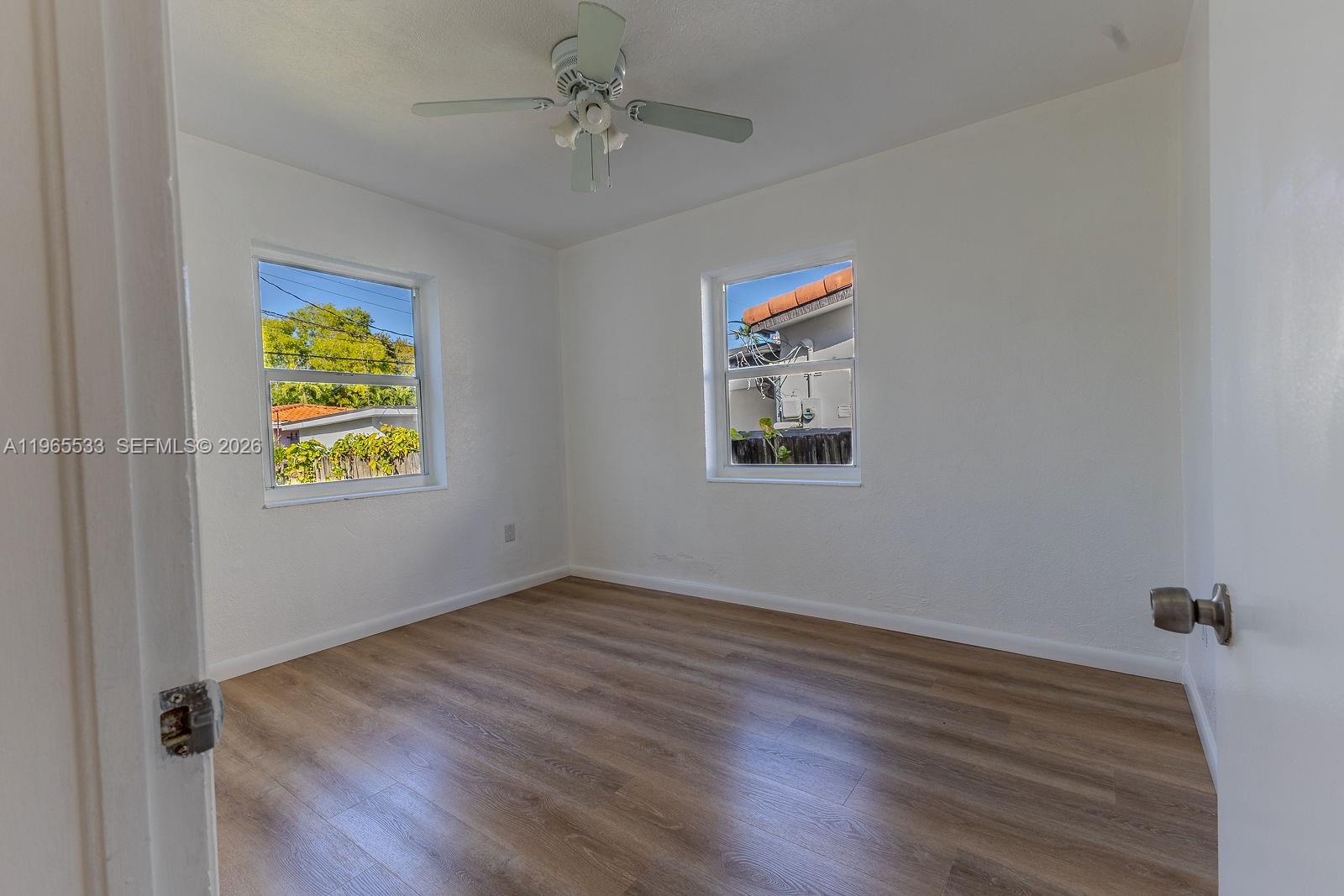 1441 Southwest 17th Street Miami, FL 33145 - Photo 20 of 26 a view of room with window and wooden floor
