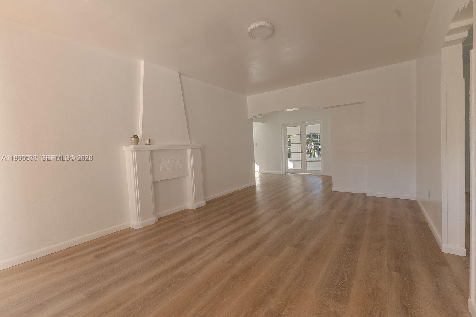 1441 Southwest 17th Street Miami, FL 33145 - Photo 9 of 26 a view of an empty room with wooden floor