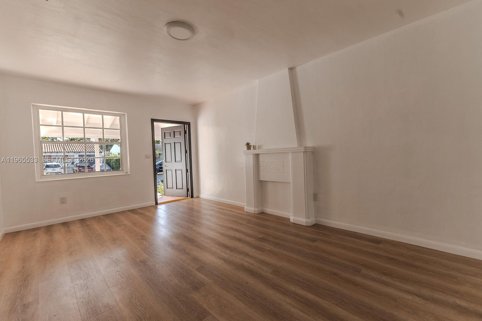 1441 Southwest 17th Street Miami, FL 33145 - Photo 10 of 26 an empty room with wooden floor and windows