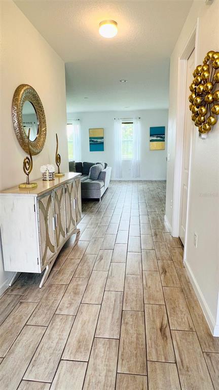 1257 Castlevecchio Loop Orlando, FL 32825 - Photo 11 of 12 a view of living room with a baby crib furniture and a window