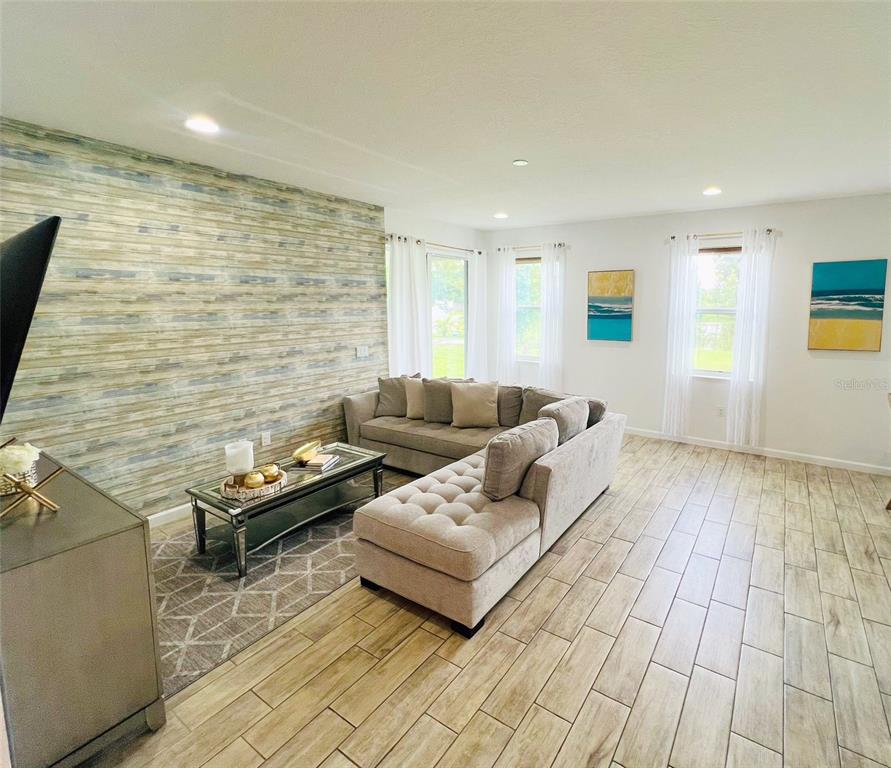 1257 Castlevecchio Loop Orlando, FL 32825 - Photo 12 of 12 a living room with furniture and a flat screen tv