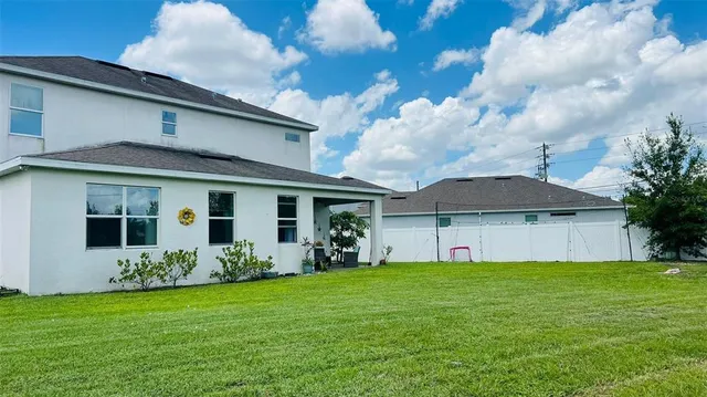 a front view of house with yard and green space