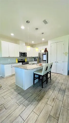 a kitchen with a sink cabinets and window