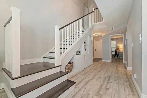 a view of entryway and hall with wooden floor