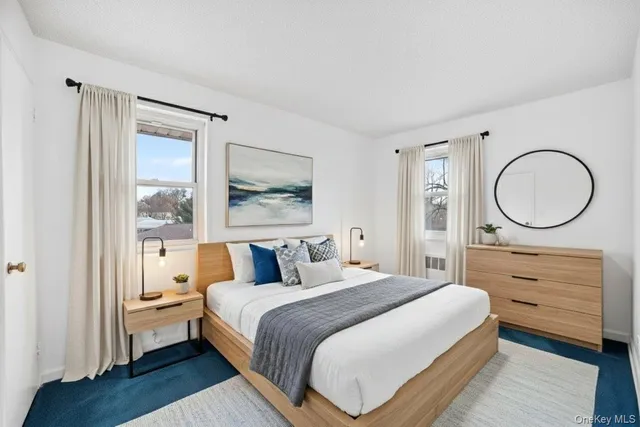 a bedroom with a bed a mirror and a window