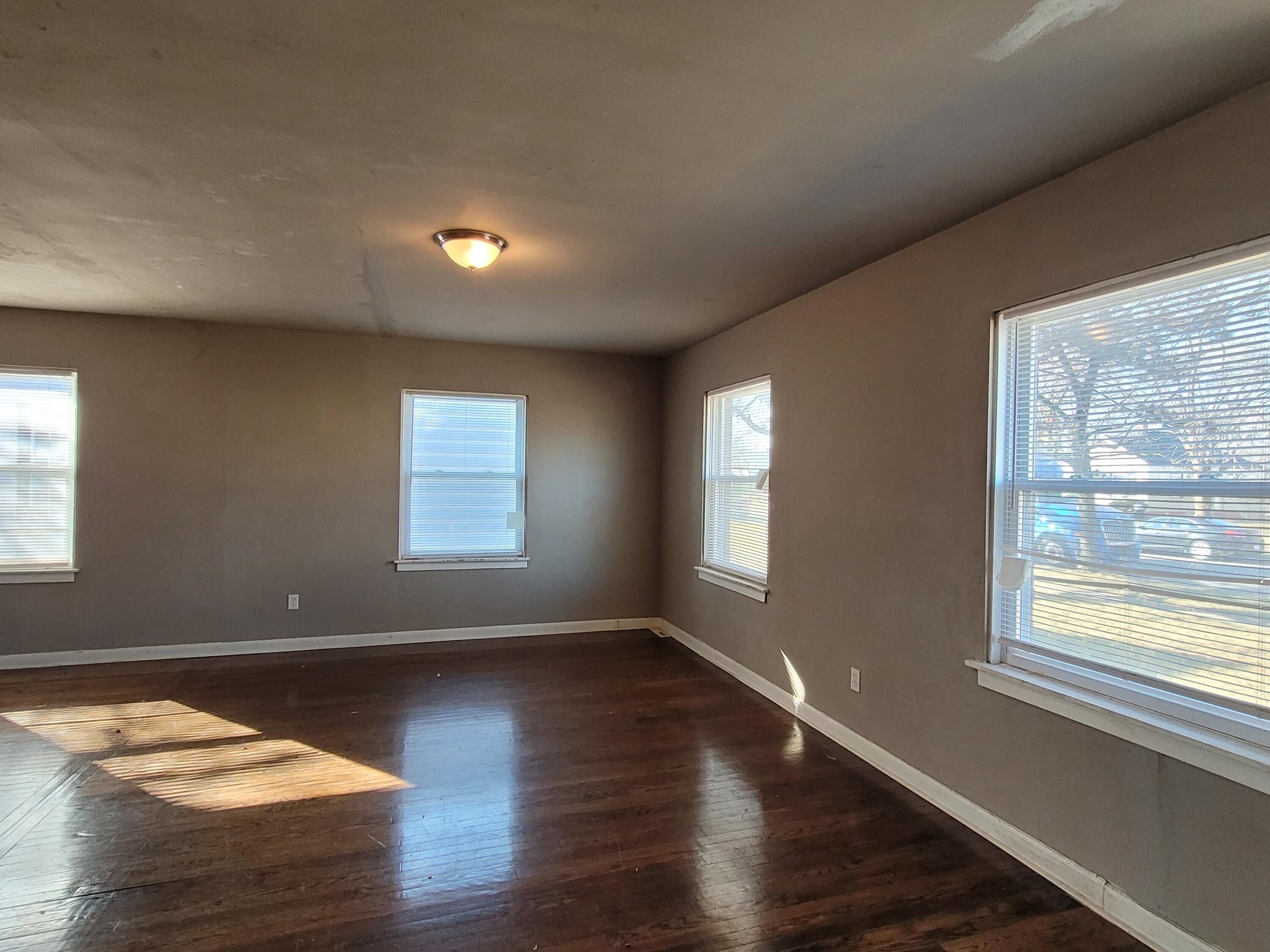 231 Taft Place Gary, IN 46404 - Photo 3 of 14 a view of an empty room with wooden floor and a window