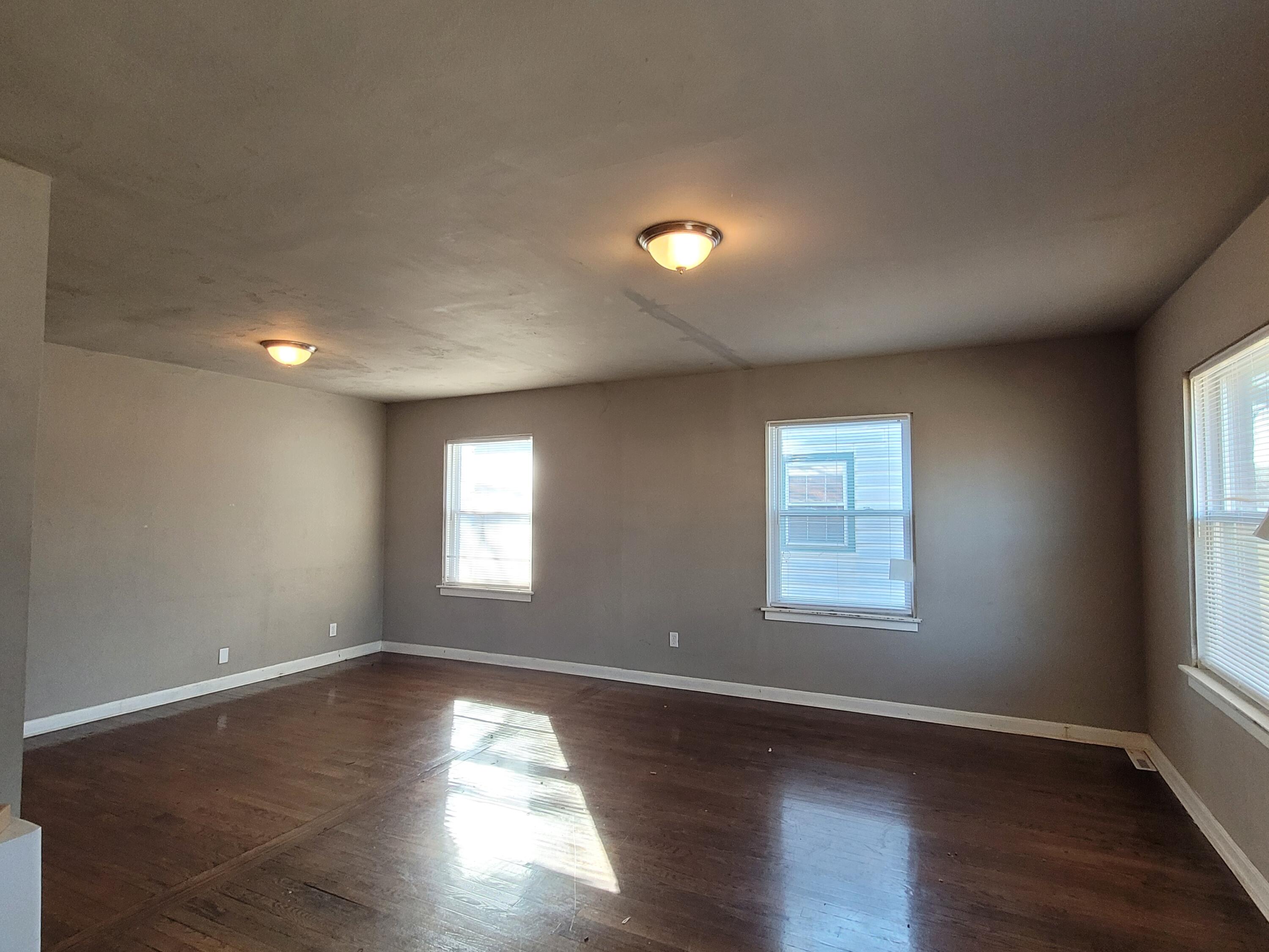 231 Taft Place Gary, IN 46404 - Photo 4 of 14 a view of empty room with wooden floor and fan