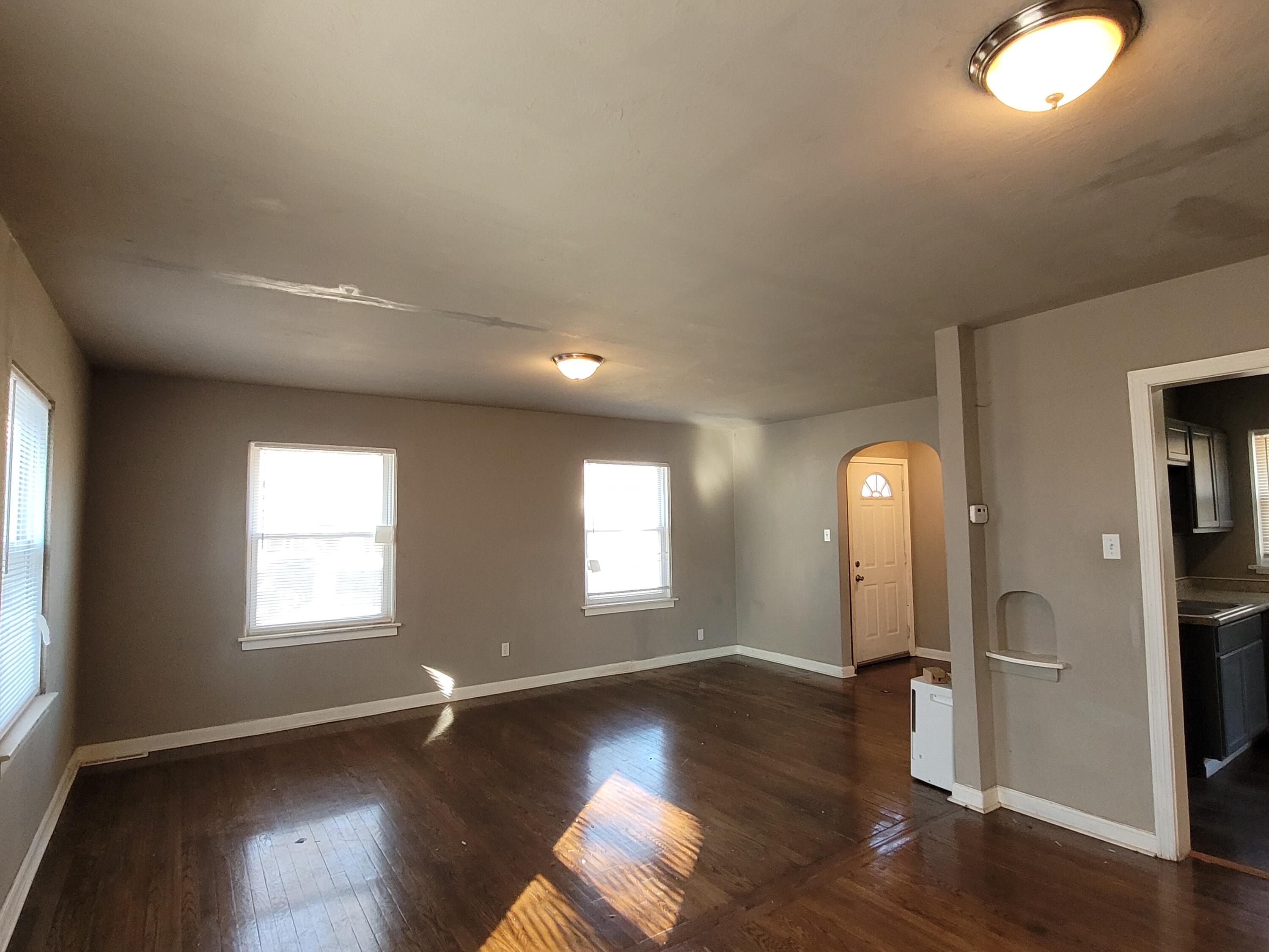 231 Taft Place Gary, IN 46404 - Photo 5 of 14 an empty room with wooden floor and windows