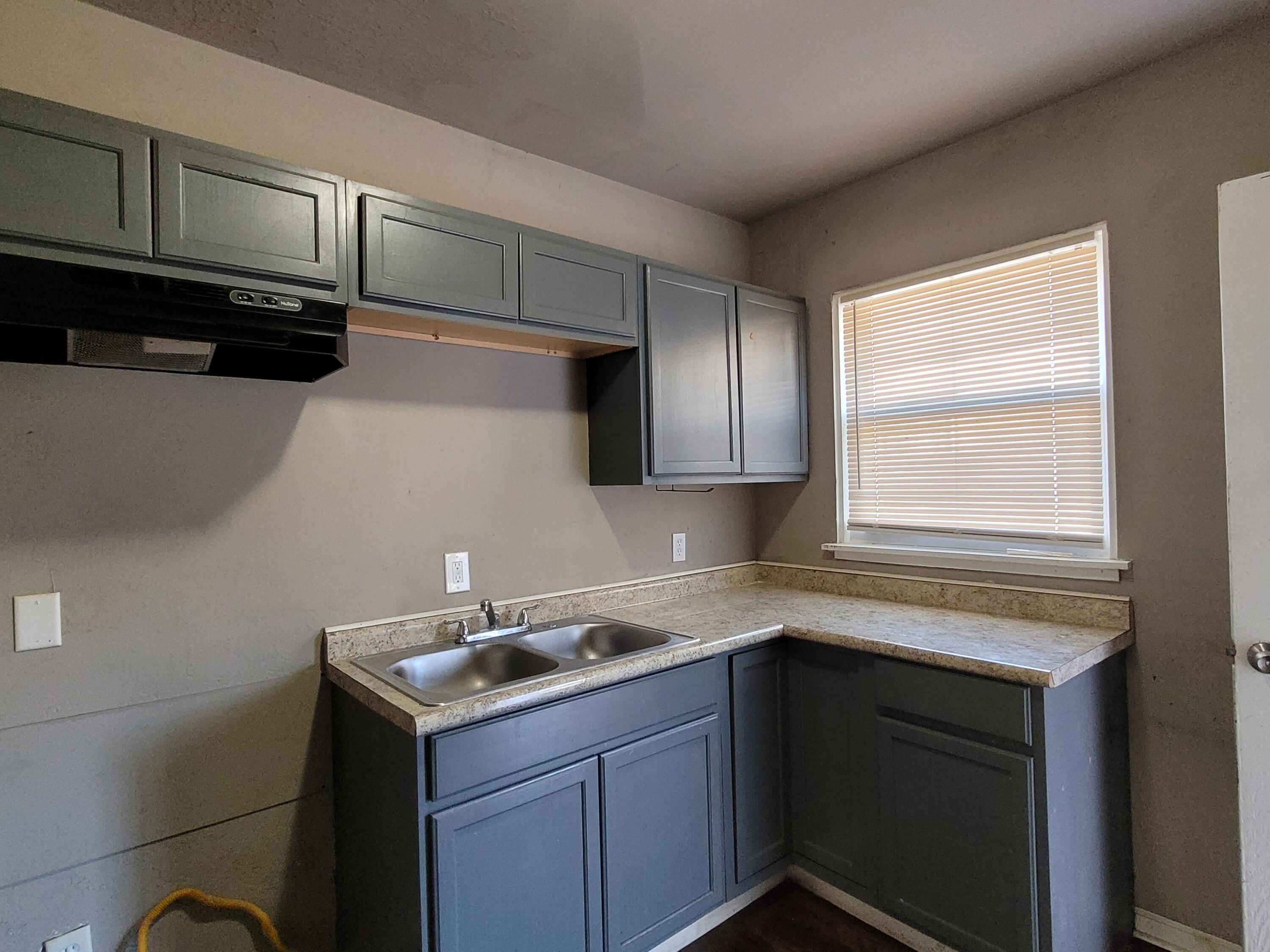 231 Taft Place Gary, IN 46404 - Photo 6 of 14 a kitchen with a sink cabinets and stainless steel appliances
