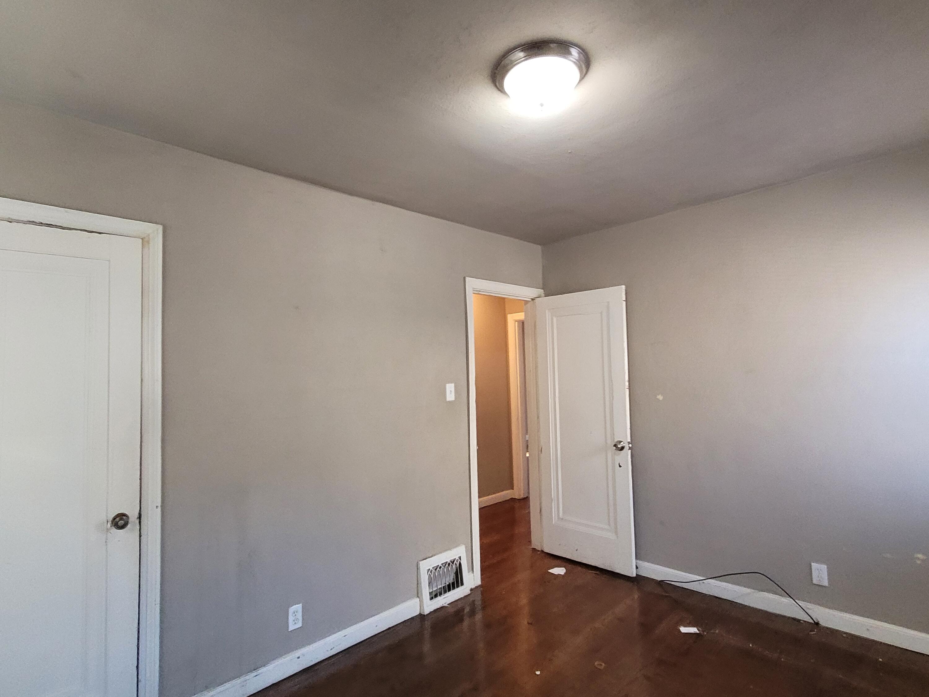 231 Taft Place Gary, IN 46404 - Photo 9 of 14 an empty room with wooden floor and windows