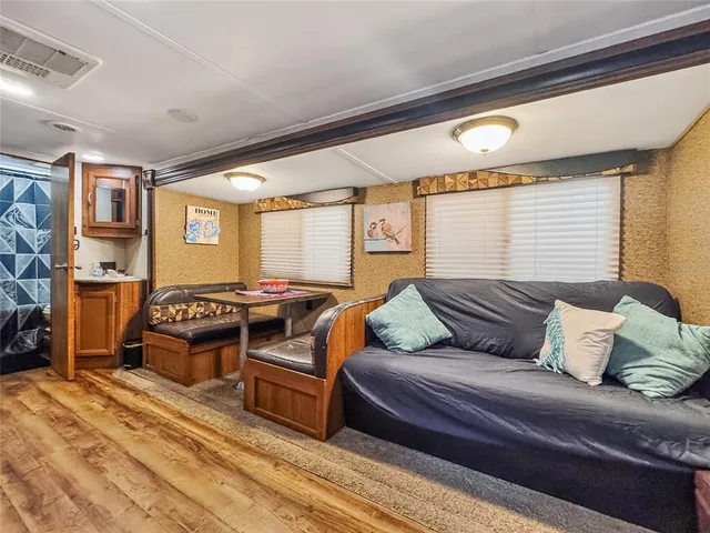 a bedroom with furniture and a large window