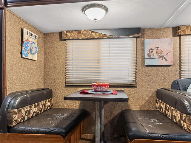 a view of a dining room with furniture and window