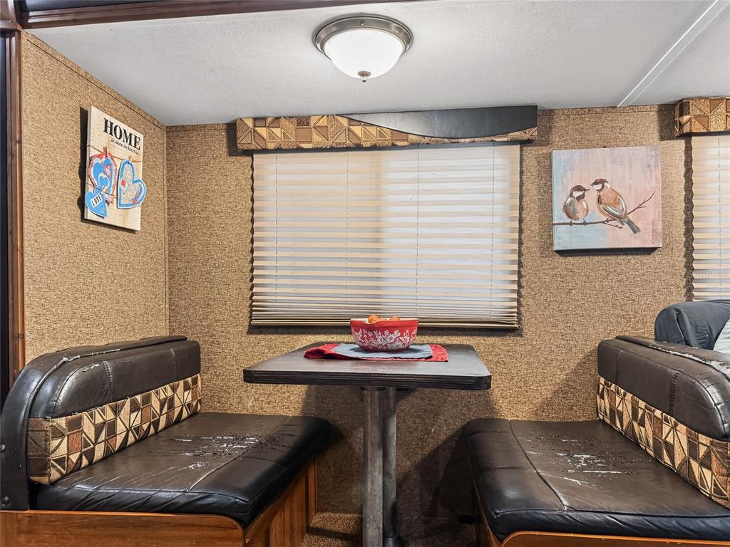 25184 Northeast 143rd Place Salt Springs, FL 32134 - Photo 14 of 42 a view of a dining room with furniture and window