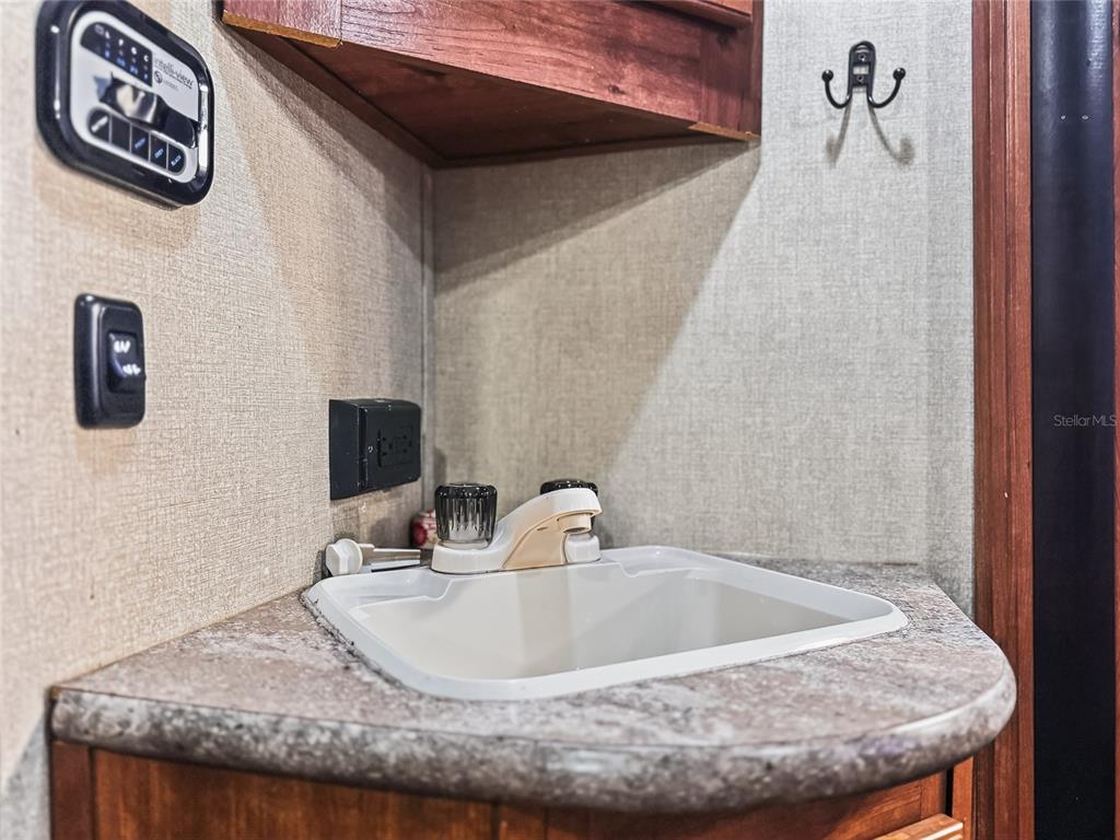 25184 Northeast 143rd Place Salt Springs, FL 32134 - Photo 16 of 42 a bathroom with a granite countertop sink and a mirror