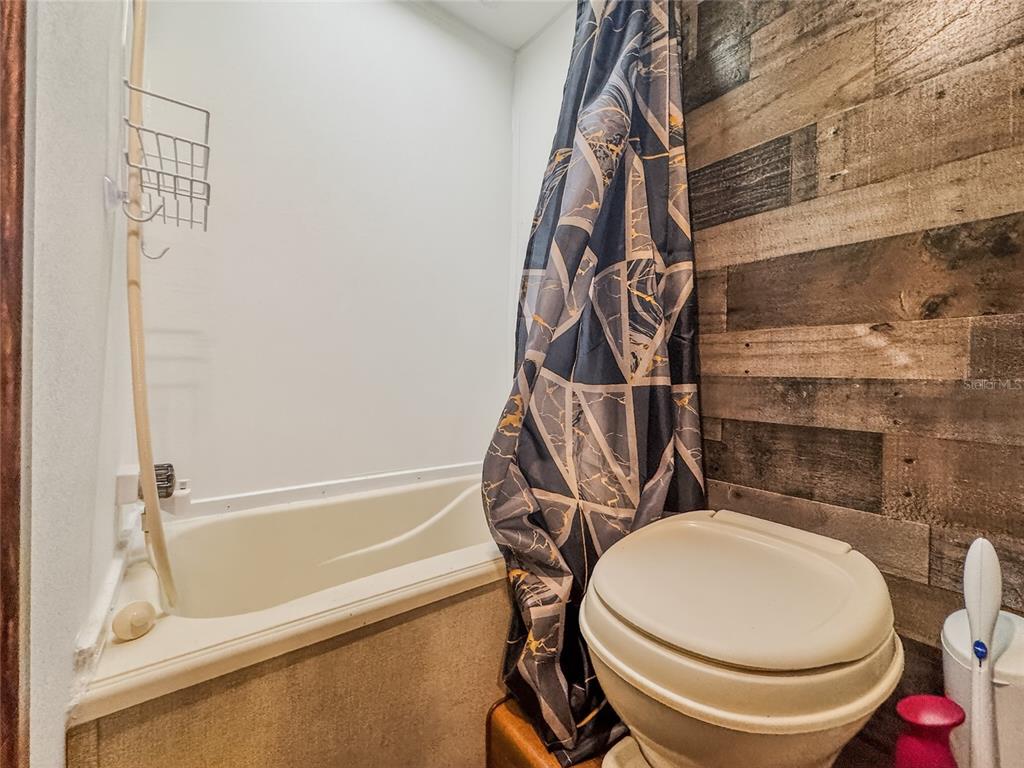 25184 Northeast 143rd Place Salt Springs, FL 32134 - Photo 17 of 42 a bathroom with a toilet and a shower