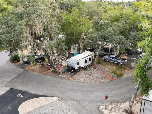 an aerial view of a house with a yard and lake view