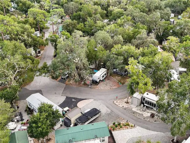 an aerial view of a house with garden space and lake view