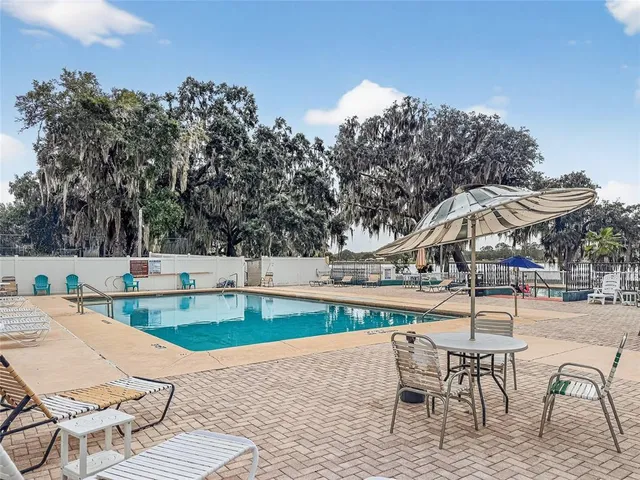 a view of a swimming pool with lounge chairs