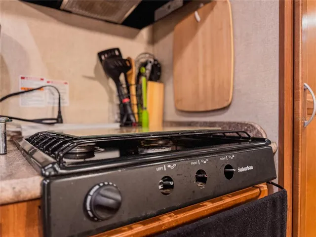 a close view of a stove a microwave and door