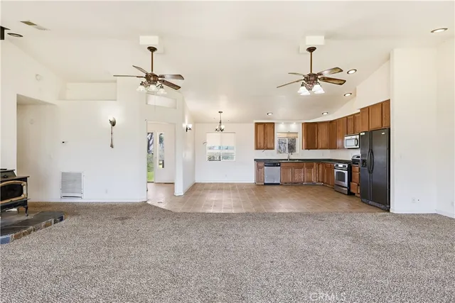 a view of a kitchen with a stove and a ceiling fan