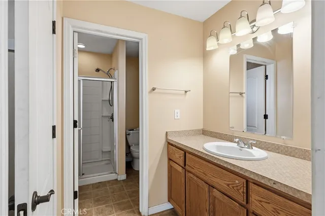a bathroom with a granite countertop sink a mirror and a shower