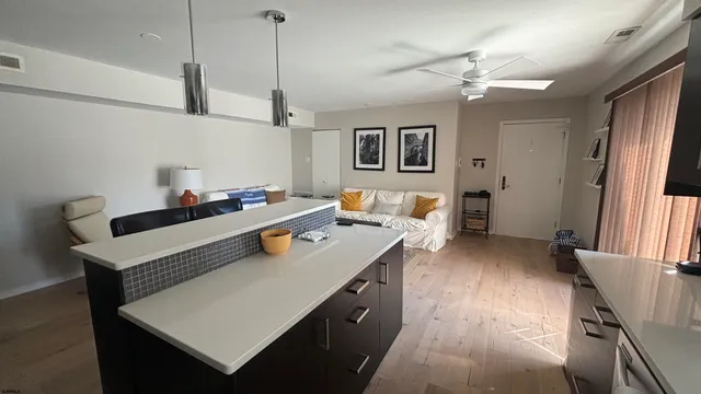 a kitchen with a sink a stove and chairs