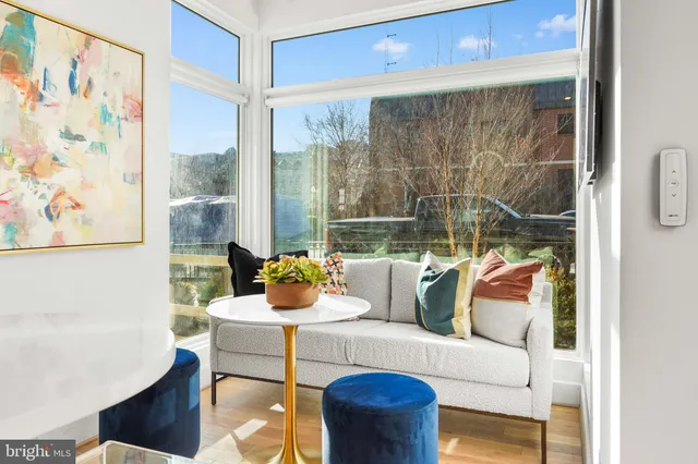 a living room with furniture and a floor to ceiling window